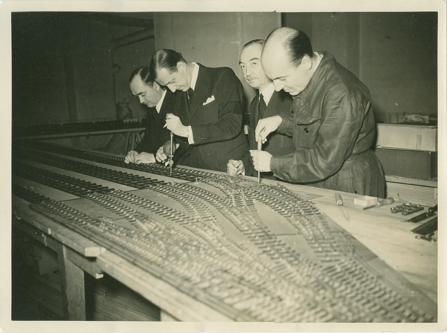 Grand Duke Dmitri at the Chateau de Beaumesnil adding the finishing touches to his railroad. 1930s.