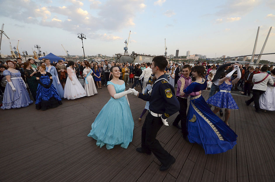 People dance during the so-called Maritime Ball on a city embankmentin the far eastern port of Vladivostok. Members of historicalclubs, cadets of the Maritime State University and other participantsattended the ball, which was held as part of the Pacific InternationalTourism Expo exhibition.