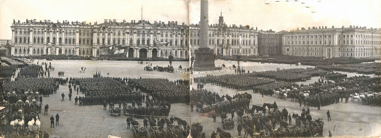 Organized columns of workers paraded in the streets of towns and cities, with music and political slogans relayed through loudspeakers. /  Panoramic view. May 1, 1930 in Leningrad (now St. Petersburg)