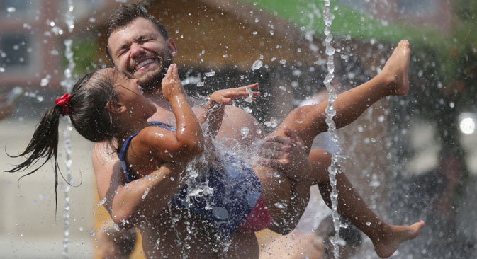 People cool off in a fountain in Muzeon Park as Moscow continues to bake in heatwave