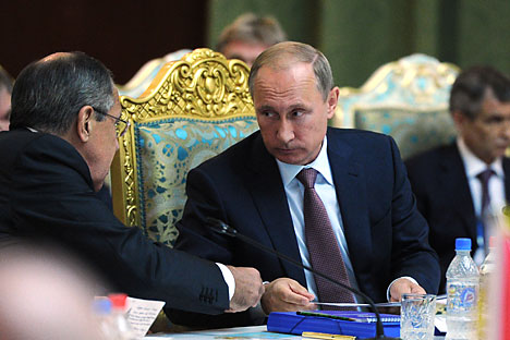 Russian President Vladimir Putin attends extended meeting of regular session of the Collective Security Council of the CSTO at the Palace of Nations in Tajikistan. Left: Russian Foreign Minister Sergey Lavrov. Background right: Deputy Russian Security Council Secretary Rashid Nurgaliyev.