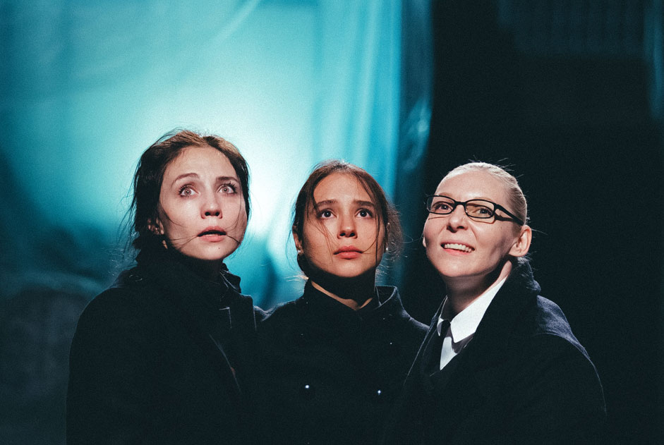 Russia. Moscow. 9 October 2015. Daria Actresses Yemelyanov (Masha), Linda Akhmetzyanova (Irina) and Irina Krivonos (Olga) (left to right) in a scene from the play "Three Sisters" Novosibirsk Drama Theater "Red Torch" directed by Timothy Kulyabina to be presented the festival "Territory" on the stage of it. Meyerhold. Performance is put on the body language, the text is translated in the form of subtitles. 