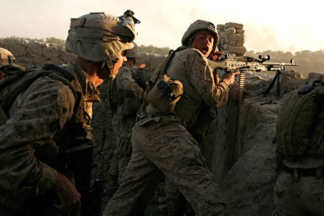U.S. marines fire during a Taliban ambush as they carry out an operation to clear an area in Helmand province, October 9, 2009. Source: Reuters 