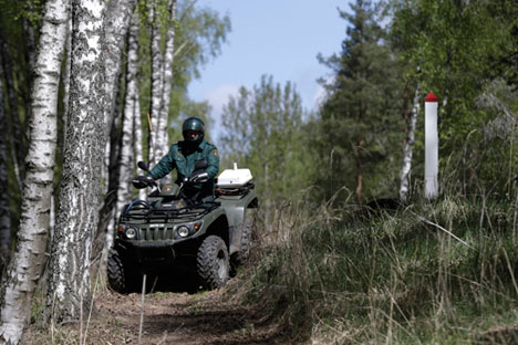 Latvian border guard Arturs Lazarevs drives a quad during a patrol at the EU external border with Russia near Opoli. Source: Reuters