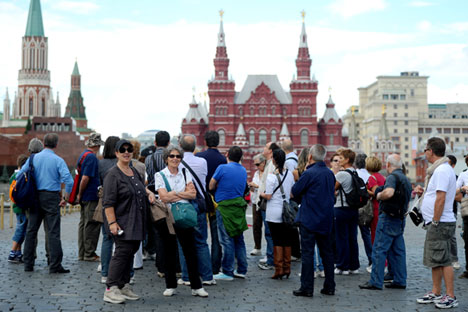 Tourists take pictures of the State Historical Museum in Moscow's Red Square.