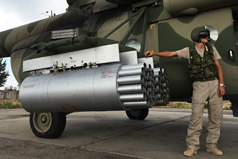 Pilot by a Russian MI-8AMShT cargo and attack helicopter at the Hmeimim air base in Syria.