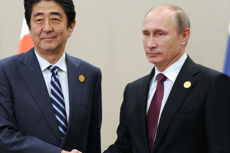Japanese Prime Minister Shinzo Abe, left, shakes hands with Russian President Vladimir Putin prior to their talks during the G-20 Summit in Antalya, Turkey, Nov. 16, 2015.