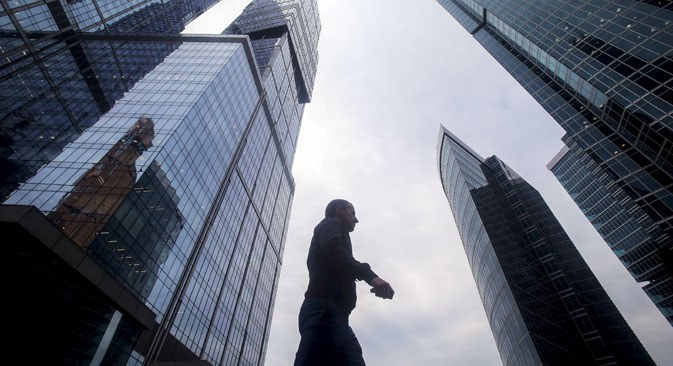 A man walks in front of the skyscrapers of the International Business Center also known as "Moskva-City" in Moscow