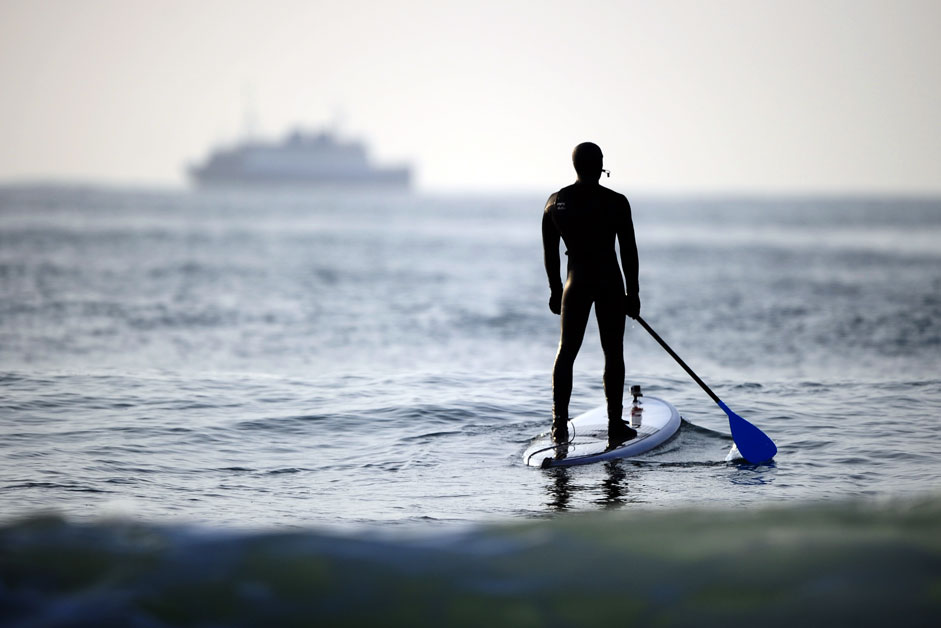 VLADIVOSTOK, RUSSIA. A surfer riding a wave at the Ussuri Bay off Russky Island.