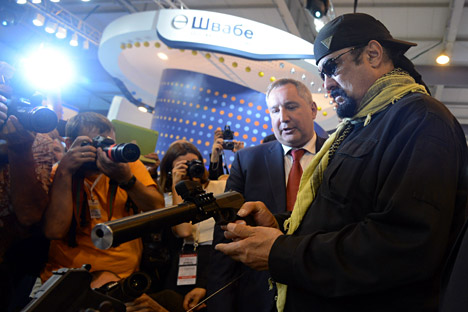 Russia's Deputy Prime Minister, chairman of the Russian Government's Military-Industrial Commission Dmitry Rogozin and famous American actor Steven Seagal with an SPS Serdyukov autoloading pistol with silencer, at the international exhibition "Oboronexpo-2014", during the 3rd International Forum "Machine-Building Technologies-2014" in Zhukovsky, Moscow Region.