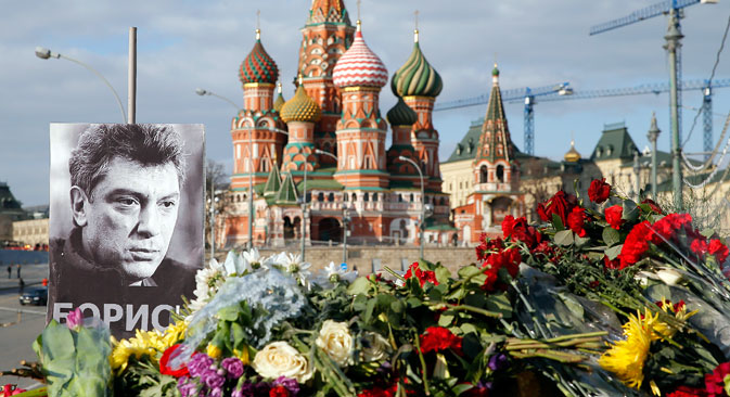 A portrait of Kremlin critic Boris Nemtsov and flowers are pictured at the site where he was killed on February 27, with St. Basil's Cathedral seen in the background, at the Great Moskvoretsky Bridge in central Moscow, March 6, 2015. 