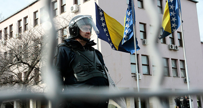 A member of the Bosnian special police forces secures the government building of the federation of Bosnia and Herzegovina during the protest in Sarajevo, Bosnia and Herzegovina, 11 February 2014.