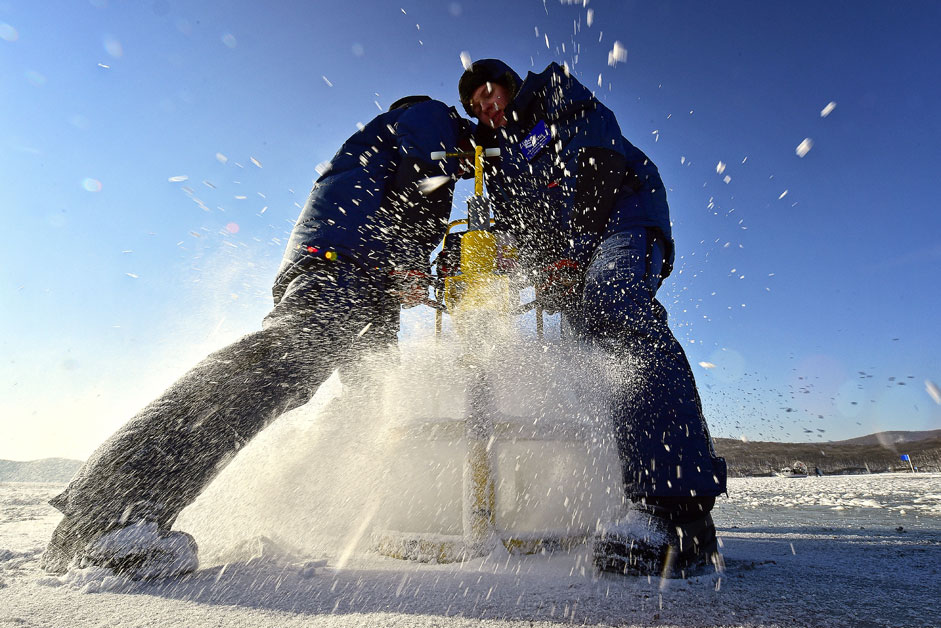  VLADIVOSTOK, RUSSIA. Students making an ice hole with an auger during a class as part of Ice Mechanics, an annual international winter course at Far Eastern Federal University, in the Novik Bay off Russky Island. The course was launched in 2015 and is aimed at advancing the development of world ocean resources. Students are to conduct experiments to test the hardness of the ice cap and to learn more about ice properties and ice structure.