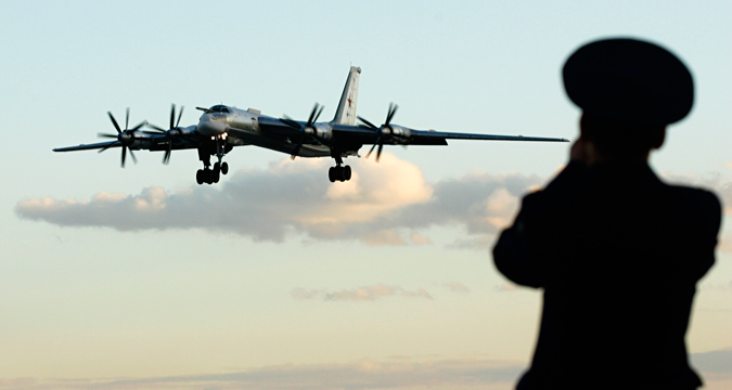 Seorang petugas Rusia mengambil foto pesawat pengebom TU-95 di sebuah pangkalan udara militer di Engels, sekitar 900 Km di selatan Moskow, 7 Agustus 2008. Kementerian Pertahanan Rusia mengundang para wartawan untuk mengikuti tur di pangkalan militer tersebut yang merupakan rumah bagi sebagian dari armada pengebom jarak jauh negara tersebut.
