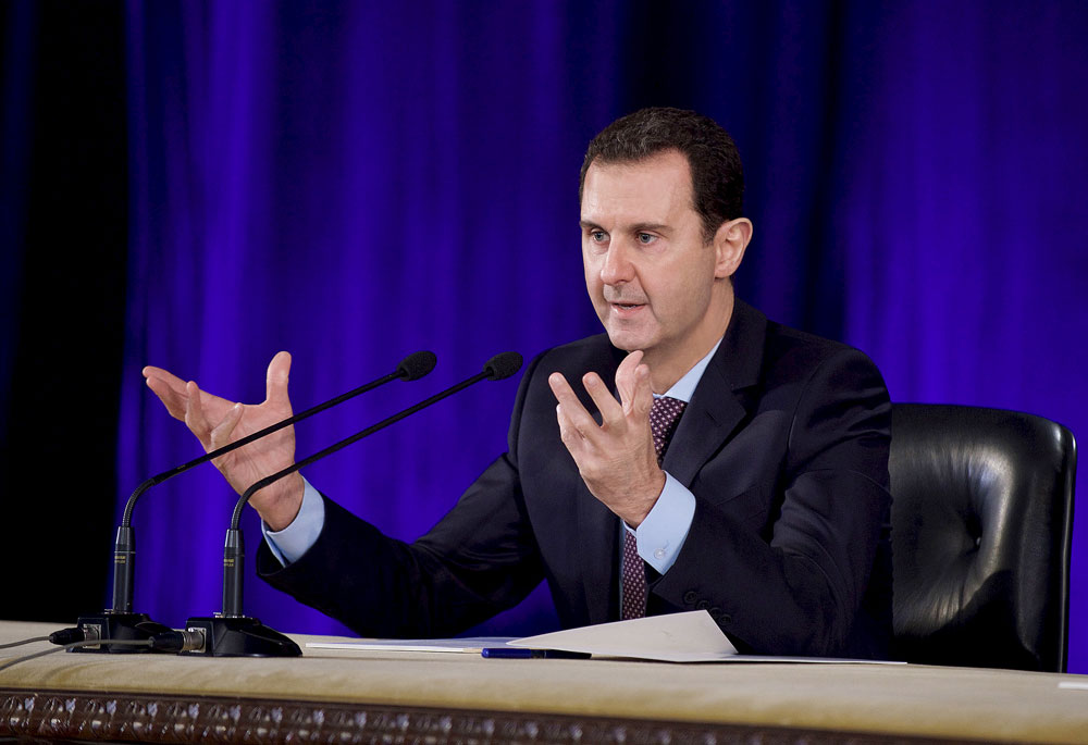Syria's President Bashar al-Assad speaks during a meeting with members of the Central Bar Association in Damascus, in this handout picture provided by SANA