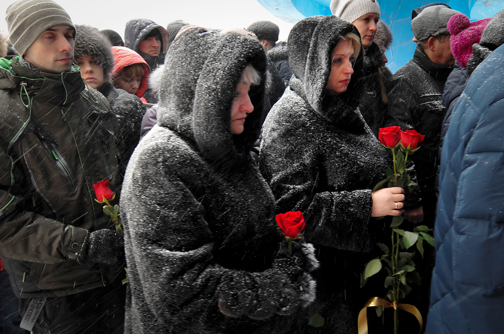 People queue to pay last respects to Vitaly Lavrov, one of the dead miners, during a funeral in Vorkuta, Feb. 29, 2016. 36 people have died at a coal mine where a methane gas leak triggered three explosions and the collapse of the mine. 