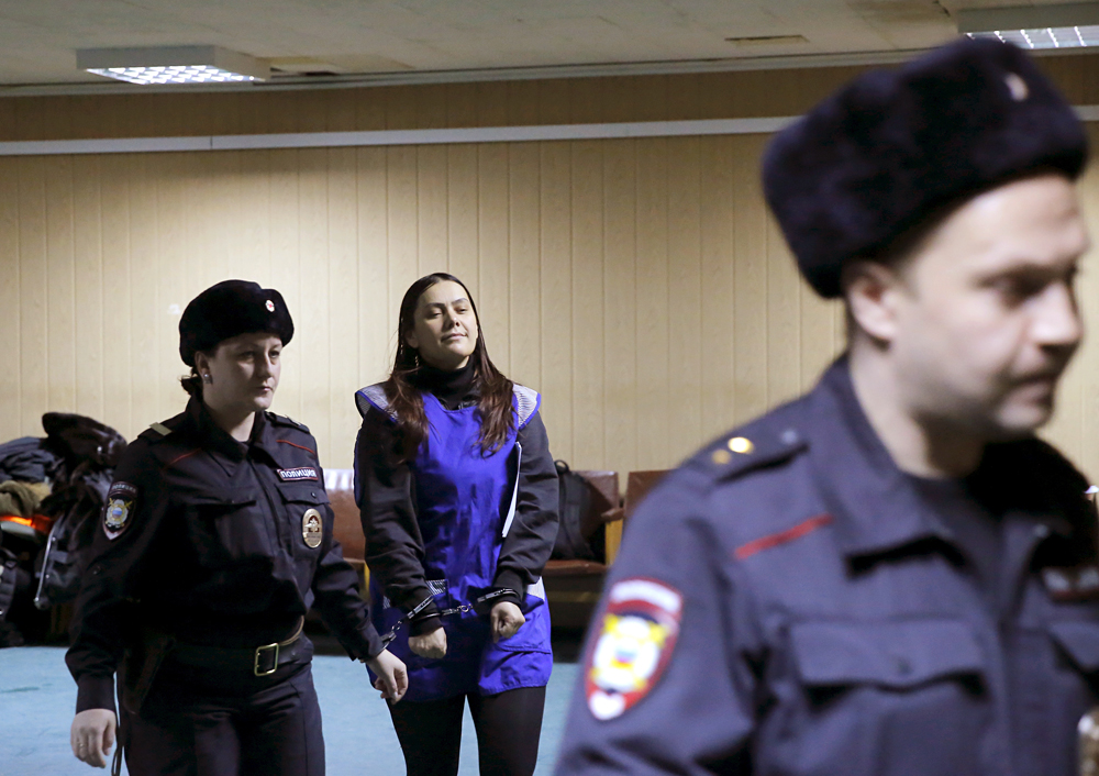 Gulchekhra (Gyulchekhra) Bobokulova, a nanny suspected of murdering a child in her care, is escorted inside a court building in Moscow, March 2, 2016