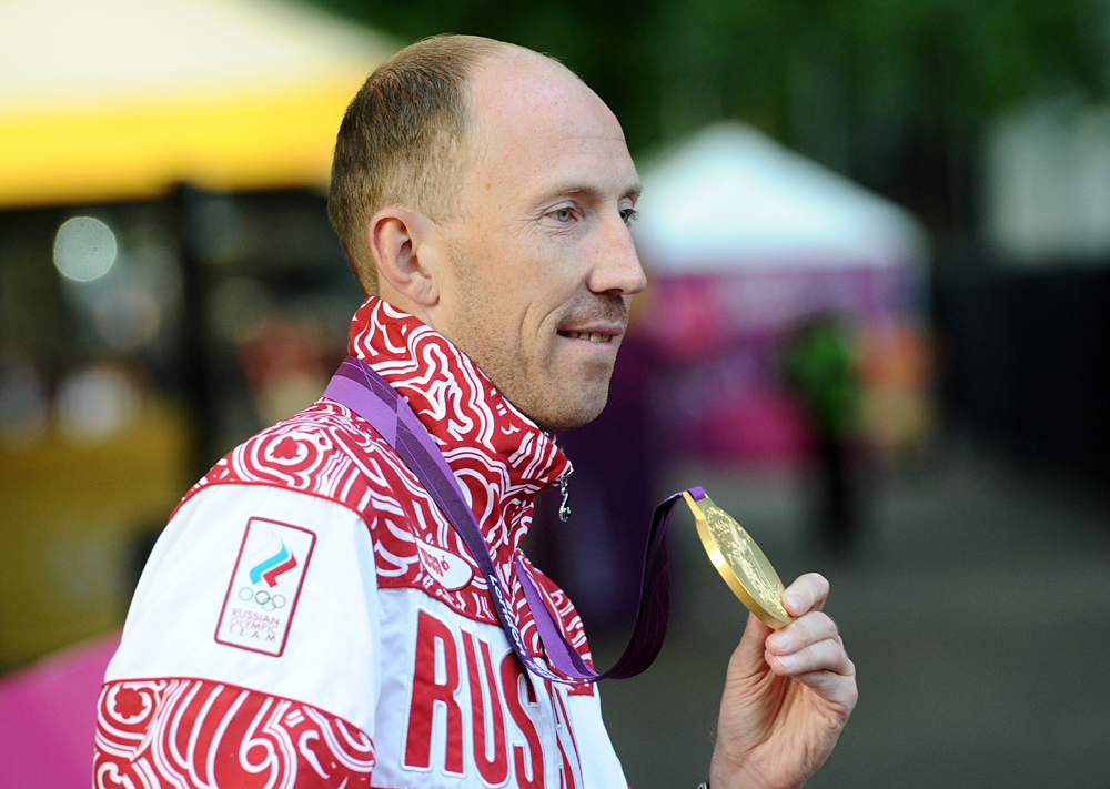 Russia's Sergey Kirdyapkin shows off his gold medal for the Men's 50km race walk at the London 2012 Olympic Games.