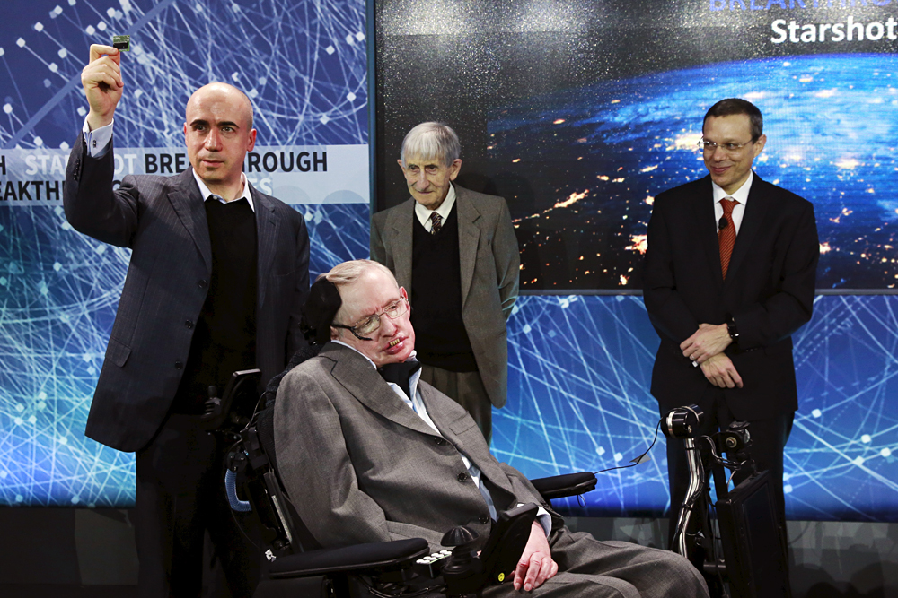 Le physicien Stephen Hawking assis devant l'investisseur Iouri Milner (à gauche), le physicien Freeman Dyson (au centre) et le physicien Avi Loeb sur la scène lors de la présentation du programme Breakthrough Starshot à New York le 12 avril 2016. 