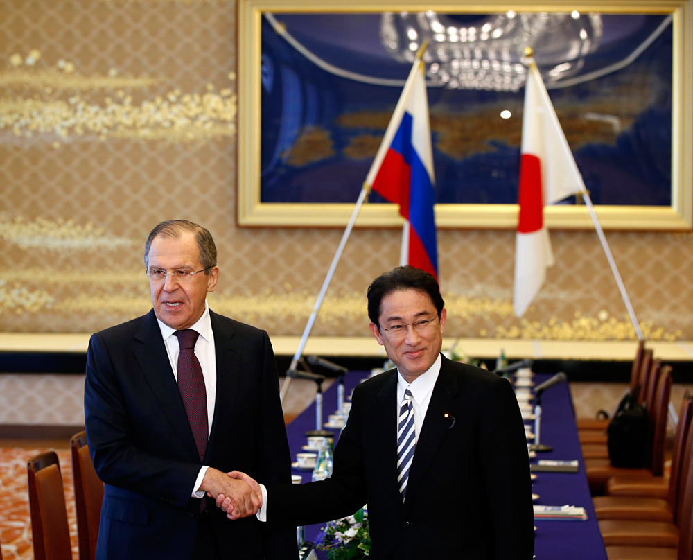 Russia's Foreign Minister Sergey Lavrov, left, and his Japanese counterpart Fumio Kishida shake hands during their meeting at the foreign ministry's Iikura guest house in Tokyo, Japan, Friday, April 15, 2016