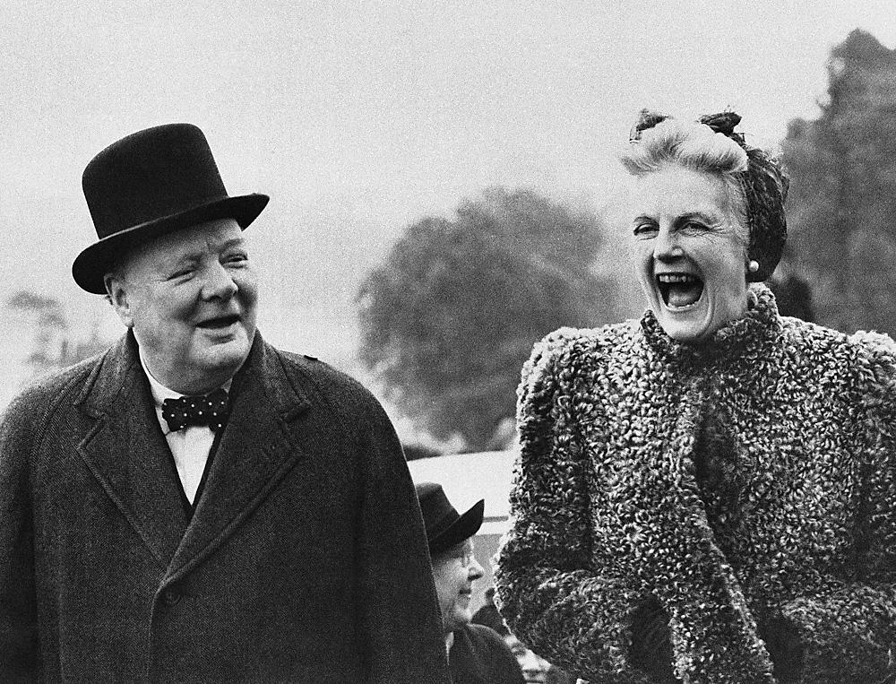 Mrs. Clementine Churchill laughs heartily as British Prime Minister Winston Churchill talks at Chigwell, England, during his election campaign, May 27, 1945. 