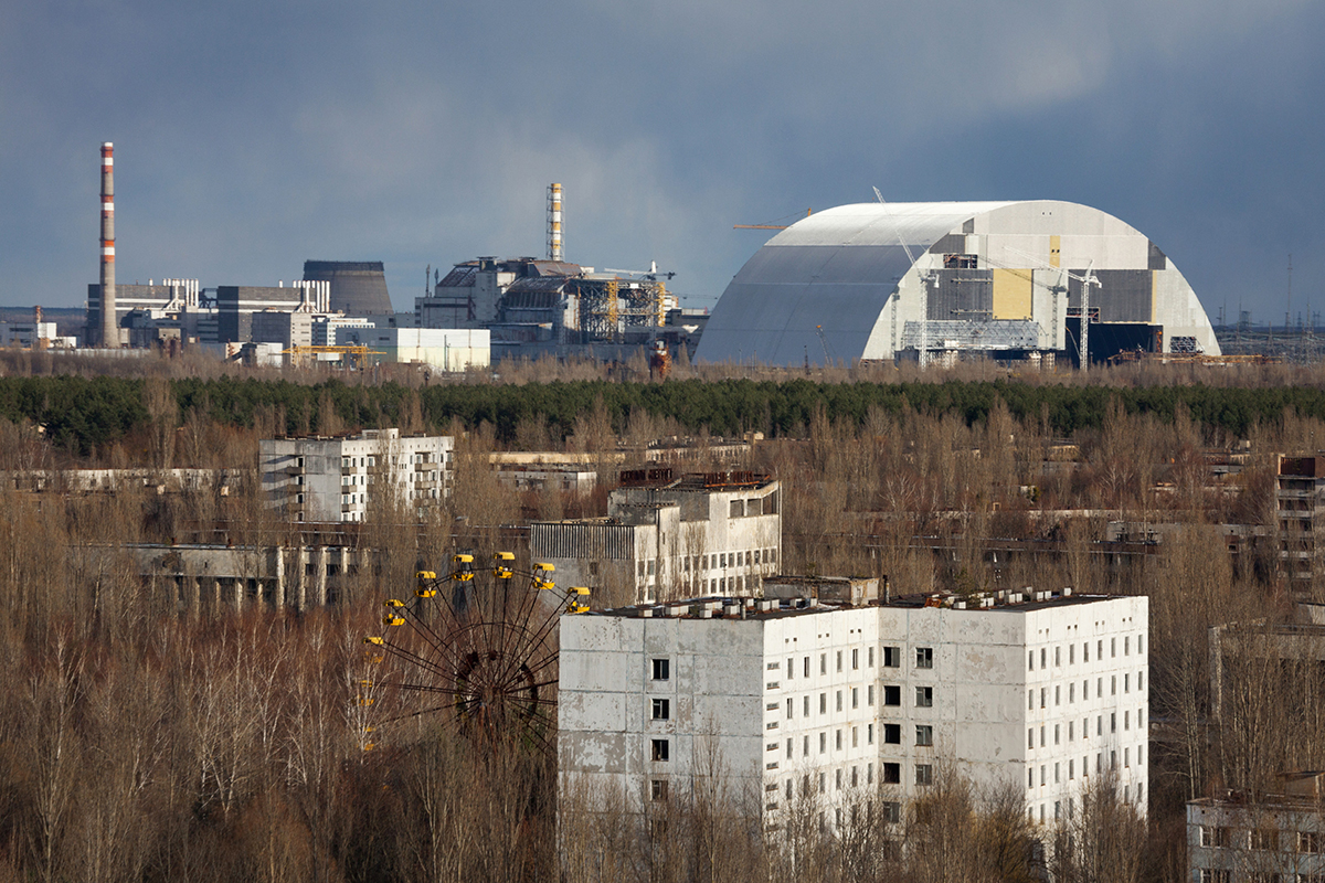 A view of the abandoned town of Pripyat, Ukraine (3 km from the nuclear station), March 19, 2016. The nuclear plant is seen in the background as well as the confinement meant to capture radioactive release.