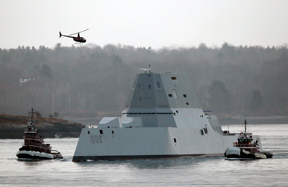 The USS Zumwalt is guided by tugboats as it arrives in Portland Harbor.