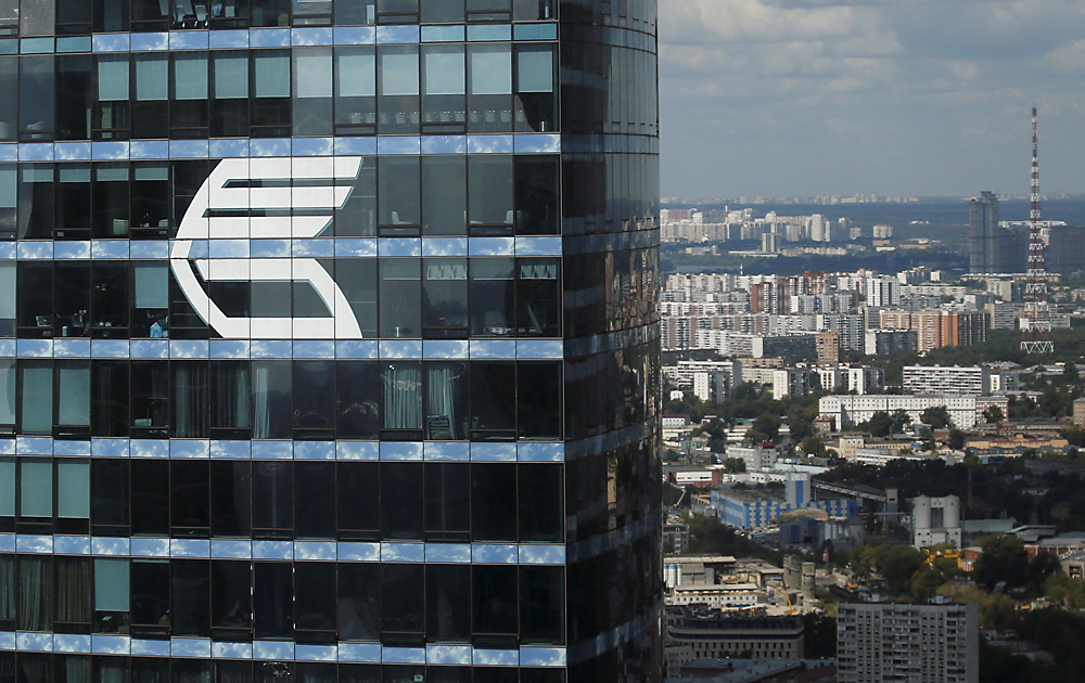 The logo of VTB Group is seen through a window of Imperia Tower on a facade of the Federation Tower at the Moskva-City. 