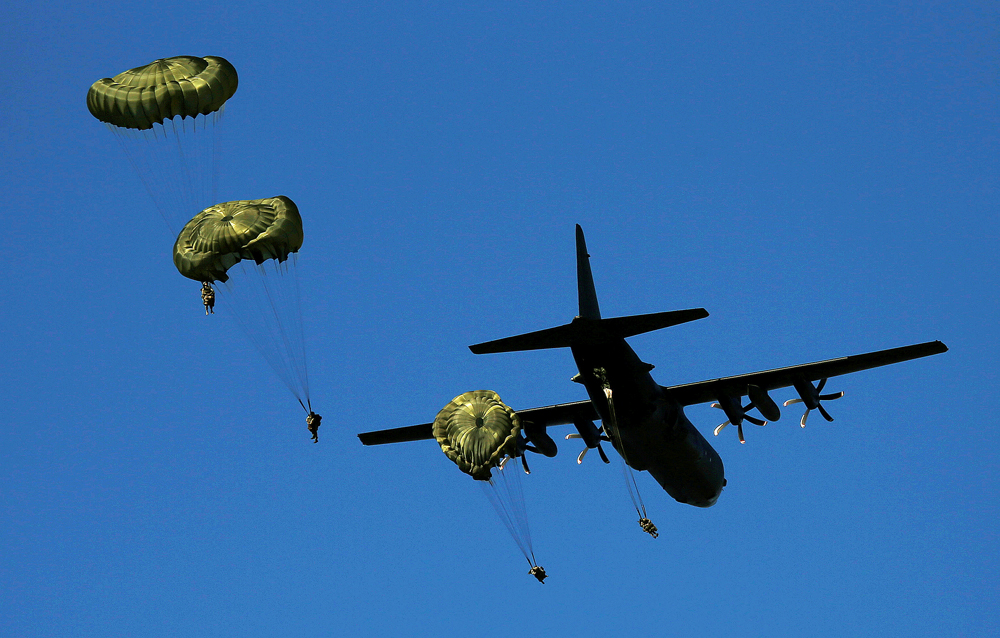 Paracaidistas británicos saltan desde un avión Hércules C-130 durante ejercicios de la OTAN cerca de Torun, Polonia. 