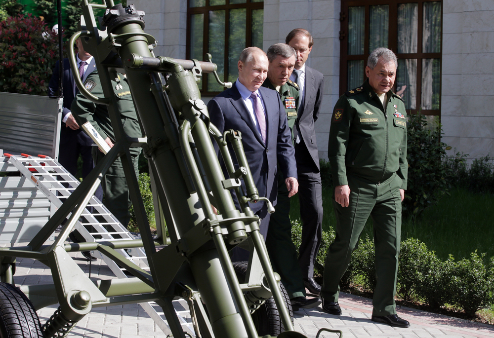 Russia's President Vladimir Putin, Army General Valery Gerasimov, Chief of the General Staff of the Russian Armed Forces, Russia's Industry and Trade Minister Denis Manturov and Russia's Defense Minister Sergei Shoigu inspect military equipment, Sochi, May 12, 2016.