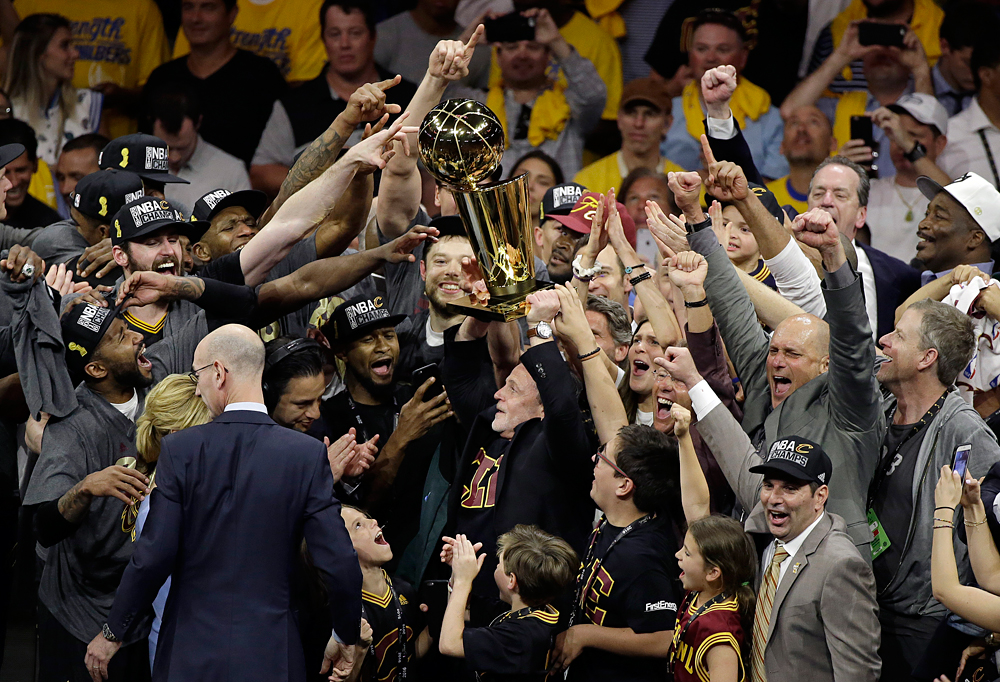 Cleveland Cavaliers players and staff celebrate after Game 7 of basketball's NBA Finals between the Golden State Warriors and the Cavaliers in Oakland, Calif., Sunday, June 19, 2016. The Cavaliers won 93-89.