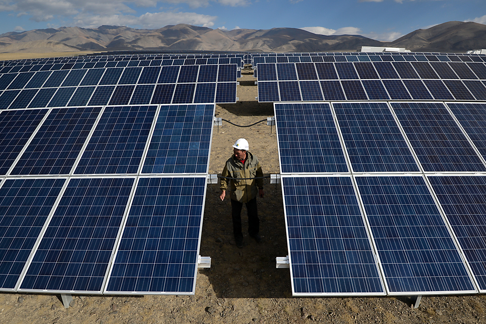 Solar power expert reviews solar panels at the Kosh-Agachskaya solar power plant in the Republic of Altai, launched on September 4, 2014.