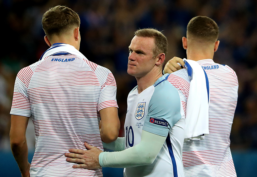 Wayne Rooney (C) reacts at the end of the UEFA EURO 2016 round of 16 match between England and Iceland at Stade de Nice in Nice, France, 27 June 2016. England lost the match 1-2. 