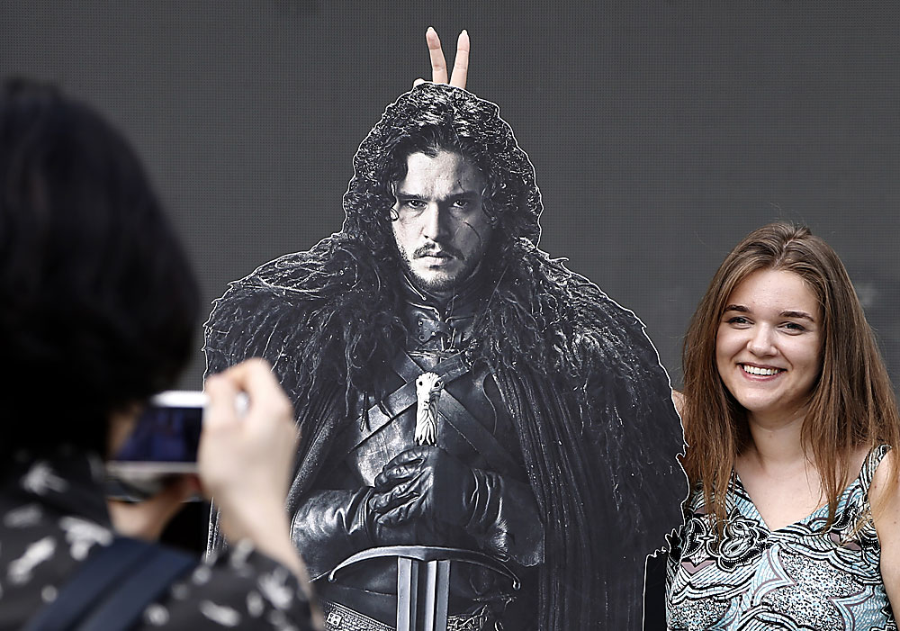 A visitor poses for pictures during the Game of Thrones festival in Moscow, Russia, 02 July 2016. The festival runs one day at Moscow Hermitage Garden. 