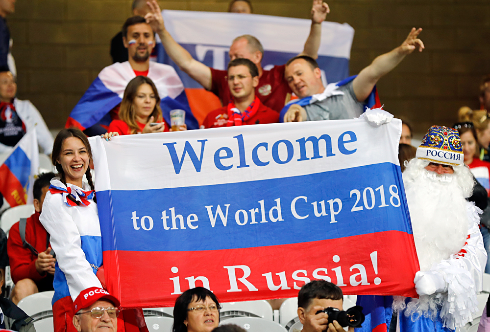 Russian supporters hold a flag reading "Welcome to the World Cup 2018 in Russia" as they wait for the start of the Euro 2016 Group B soccer match between Russia and Slovakia at the Pierre Mauroy stadium in Villeneuve d’Ascq, near Lille, France, on June 15, 2016. 
