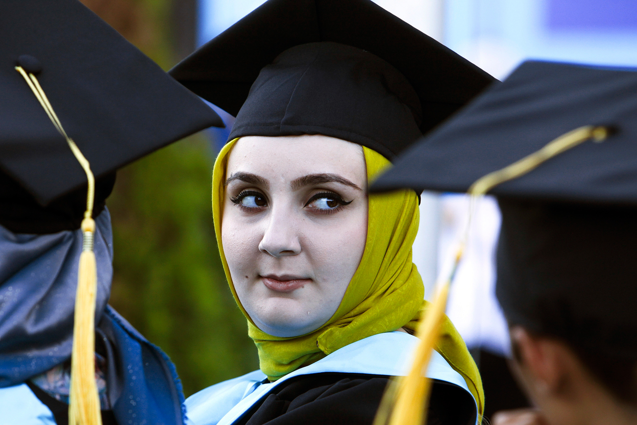 A Chechen woman, a graduate of the Chechen State University, attends a graduation ceremony in Chechnya's provincial capital Grozny, Russia