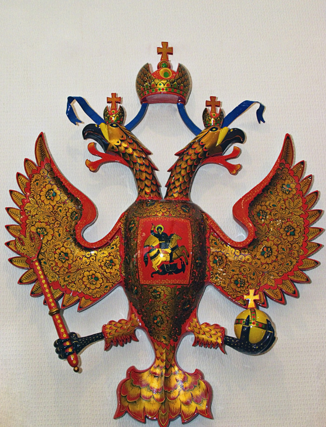 Khokhloma is a design that typically features vivid flowers and berries, with red and gold over a black background. Mostly it is used for painting wooden tableware and furniture. Why was the symbol of Russia – a two-headed eagle – colored in with khokhloma?