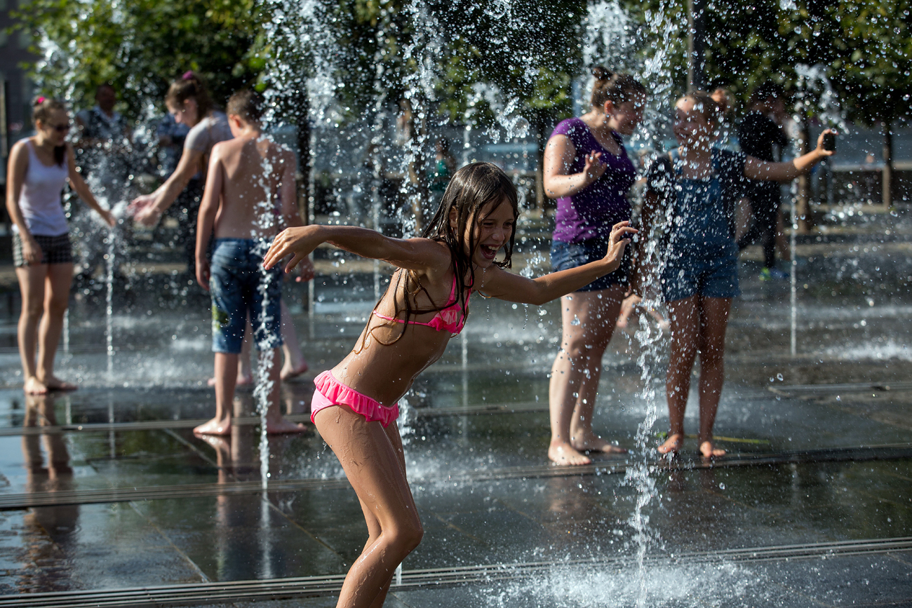 Children cool down while playing in a fountain in Moscow, Russia