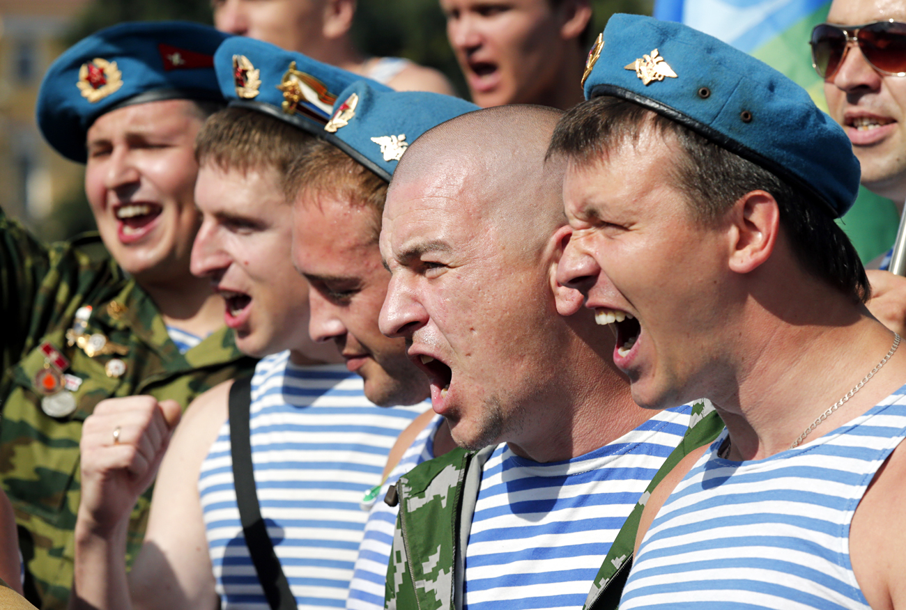 Former Russian paratroopers march and shout slogans during the Russian 'Paratroopers Day' celebrations at Dvortsovaya Square in St. Petersburg. 