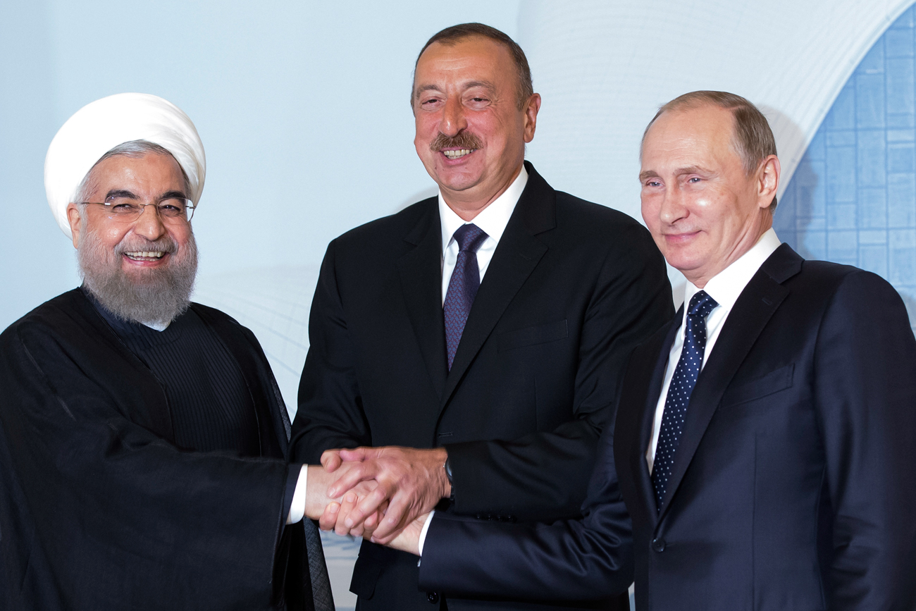 Iranian President Hassan Rouhani, left, Azerbaijan's President Ilham Aliyev, center, and Russian President Vladimir Putin pose for a photo during their meeting in Baku, Azerbaijan, Monday, Aug. 8, 2016.