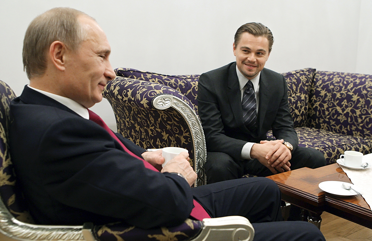 Russia's Vladimir Putin (L) in his capacity as prime minister listens to actor Leonardo DiCaprio during their meeting in St. Petersburg on Nov. 23, 2010.