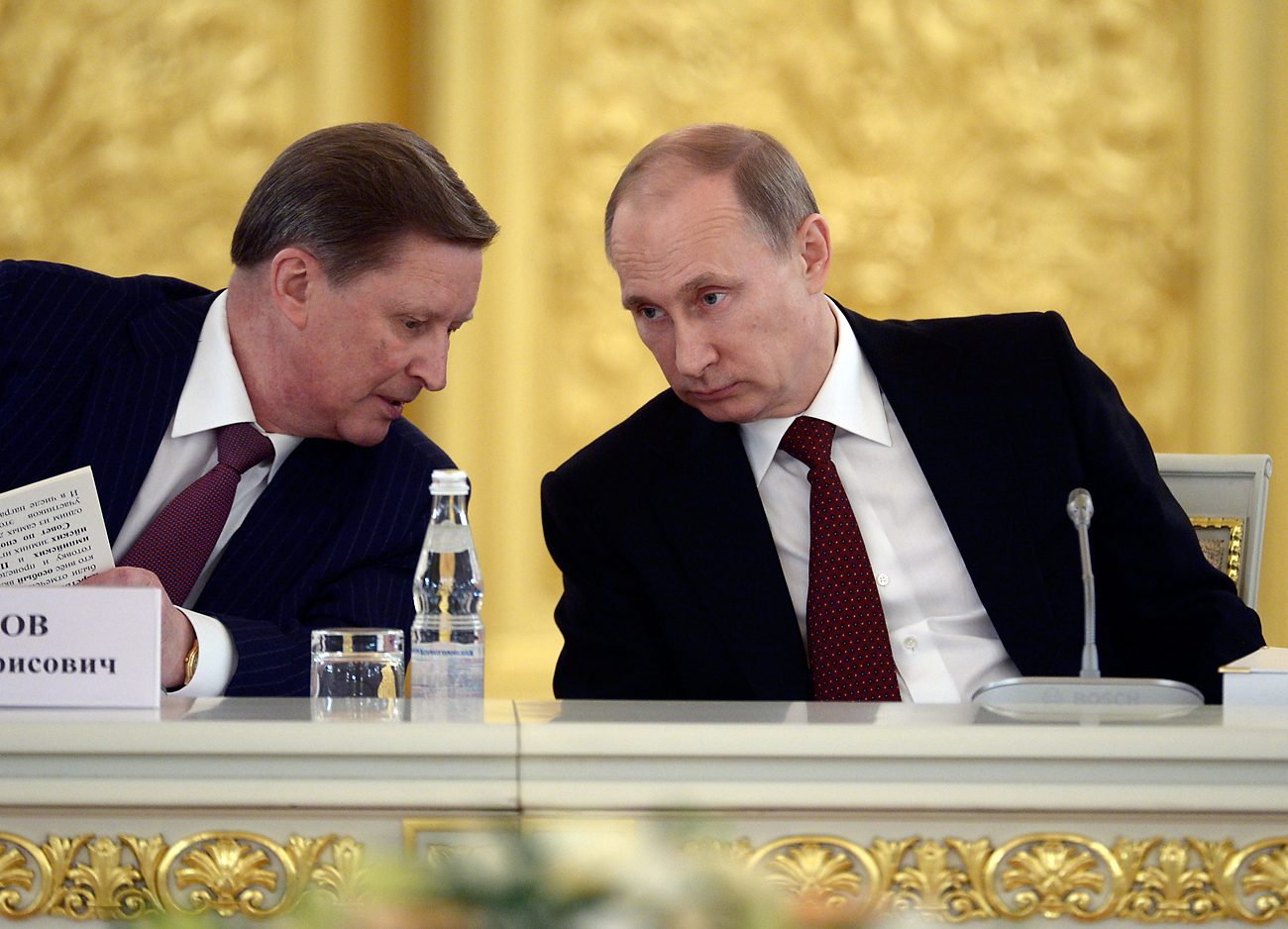 Russian President Vladimir Putin speaks with Sergei Ivanov, head of the presidential administration, during a government meeting in Moscow's Kremlin on March 24, 2014.