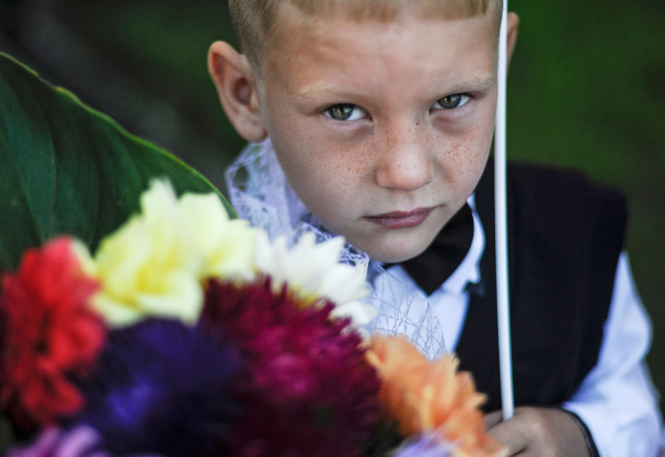 A boy attends a ceremony marking Knowledge Day at the 57th school in the village of Novolugovoye, Novosibirsk Region.