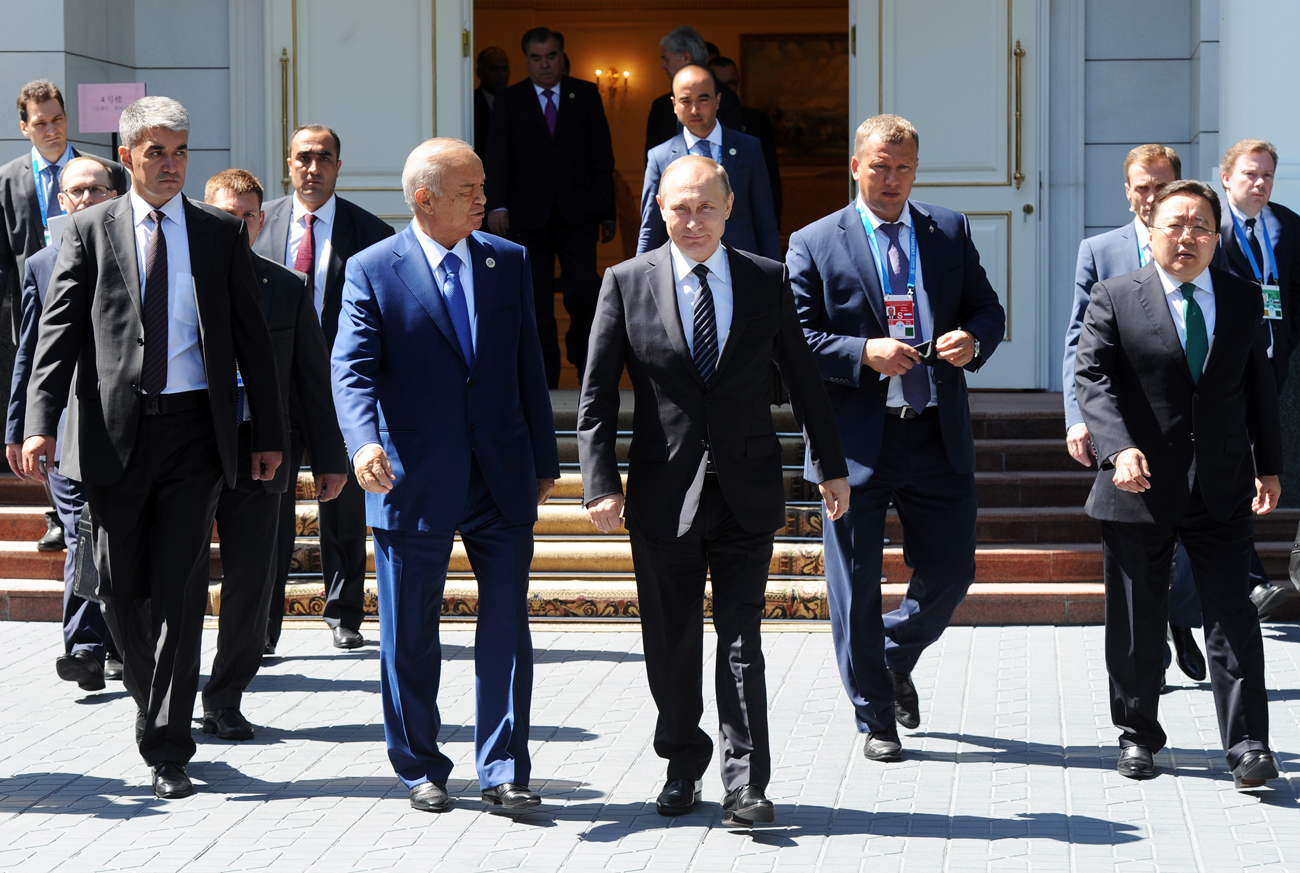 Uzbekistan's President Islam Karimov, Russia's President Vladimir Putin (L-R front), and Mongolia's President Tsakhiagiin Elbegdorj (R) following a meeting of the Shanghai Cooperation Organisation (SCO) Heads of State Council.