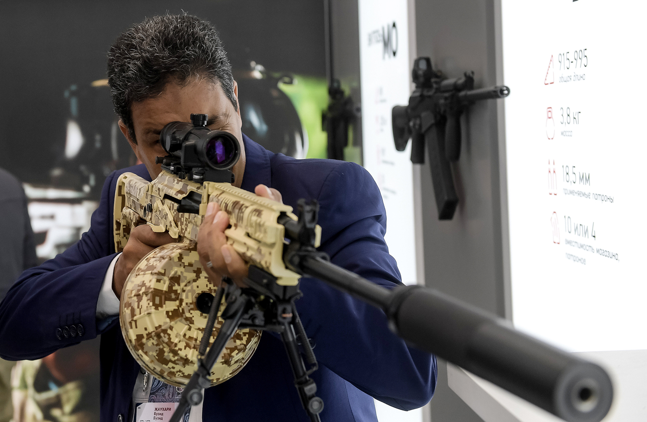 A visitor reviews an RPK-16 light machine rifle at the Kalashnikov pavilion, at the ARMY 2016 International Military Forum, at the exhibition center of the Patriot Military Park of the Russian Armed Forces in the Moscow Region.