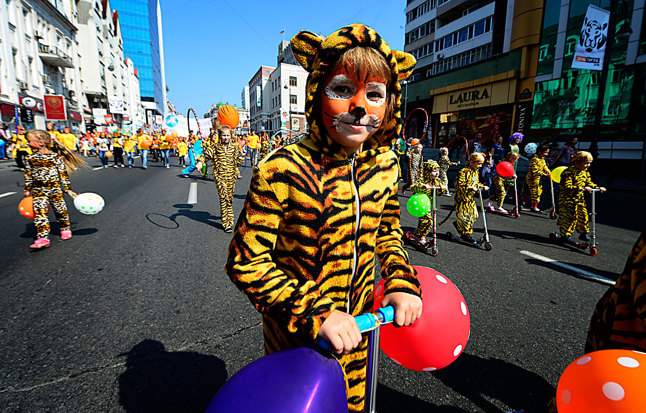 VLADIVOSTOK, RUSSIA – SEPTEMBER 25, 2016: A child dressed as a tiger takes part in a carnival parade marking Tiger Day. 