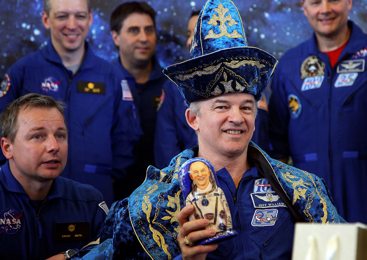 .... Or NASA astronaut. / The International Space Station crew member Jeff Williams wearing Kazakh national costume holds a Matryoshka during a news conference in Kazakhstan, 2016.