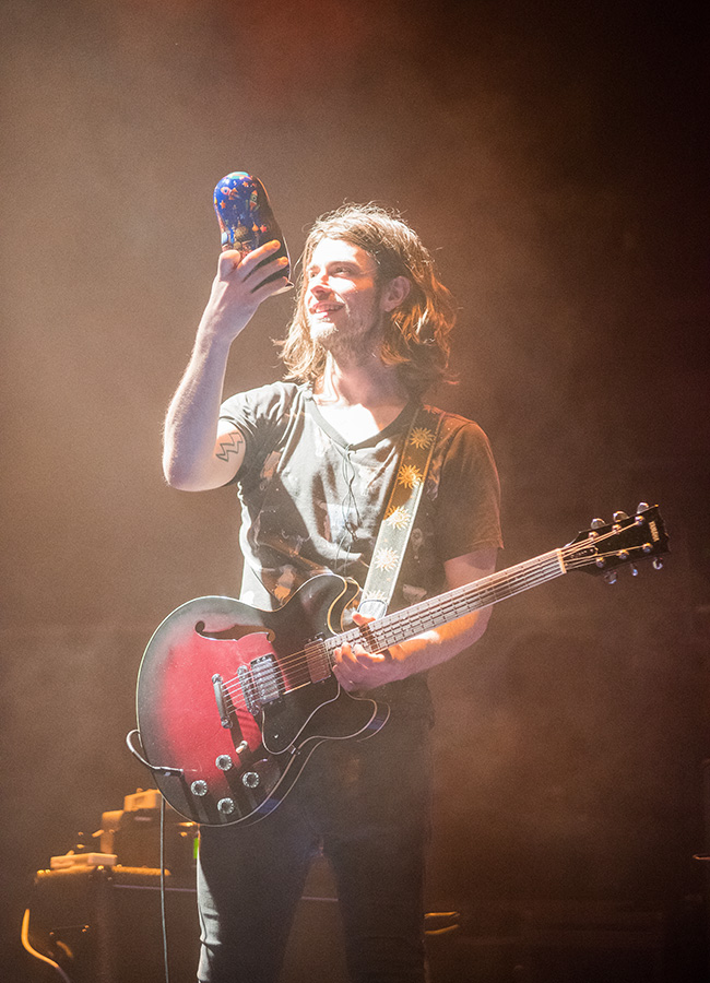 The traditional Matryoshka is a doll with a female face, wide eyes, red cheeks, pretty smile, and a braid. The hair is covered with a shawl adorned with flowers, green leaves, and a traditional Russian pattern. / Jamie Dean, the guitarist of an Irish band God Is an Astronaut during the concert in Moscow.