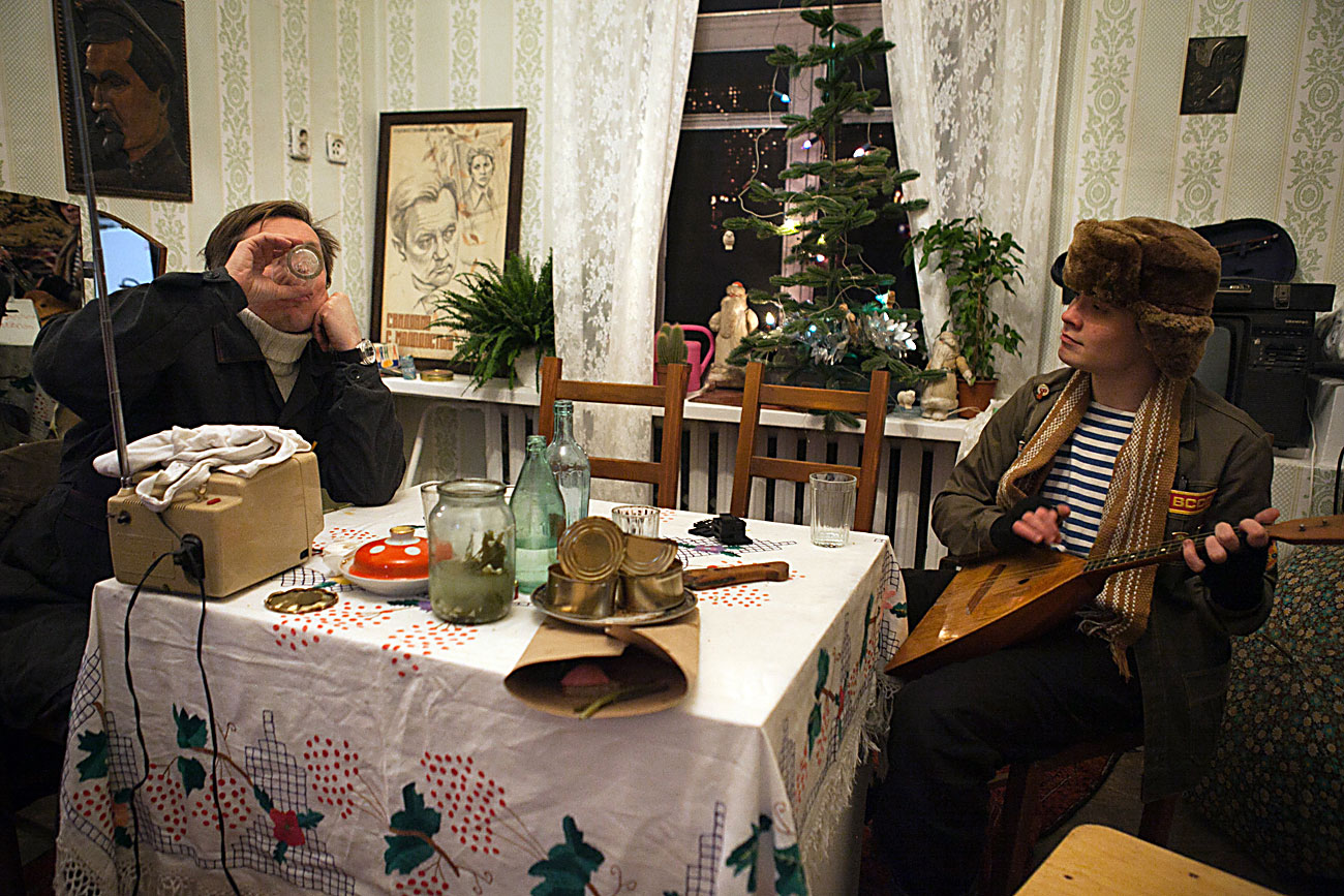 Two men drinking vodka as if they are sitting in the Soviet era kitchen room seen at the Museum of history of alcohol dependence, a part of the Museum of all the museums project, opened at the All-Russian Exhibition Centre (VDNKh) in Moscow, Russia.