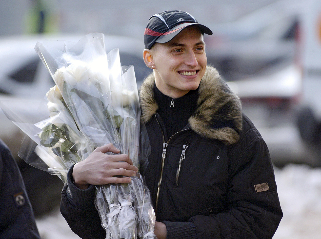 Men buy flowers on the eve of March 8, International Women's Day.